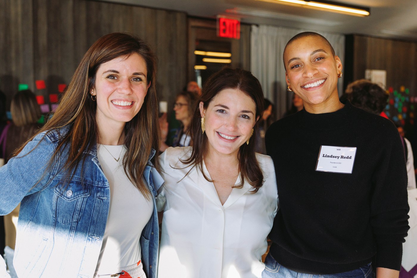 Three WELL members smiling together at the Summit
